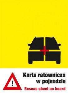 Żółta nalepka informująca o karcie ratowniczej umieszczonej w pojeździe - symbol samochodu z krzyżowym przecięciem, w środku czerwony krzyż. Pod spodem trójkąt ostrzegawczy i napis: "Karta ratownicza w pojeździe. Rescue sheet on board"