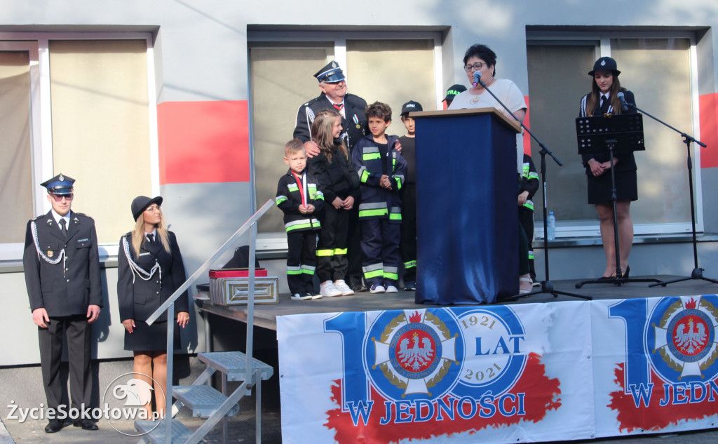 Na scenie prezes OSP Chruszczewka wraz z najmłodszymi dziećmi strażakami przyjmuje gratulacje, podziękowania oraz życzenia od mieszkanki.
