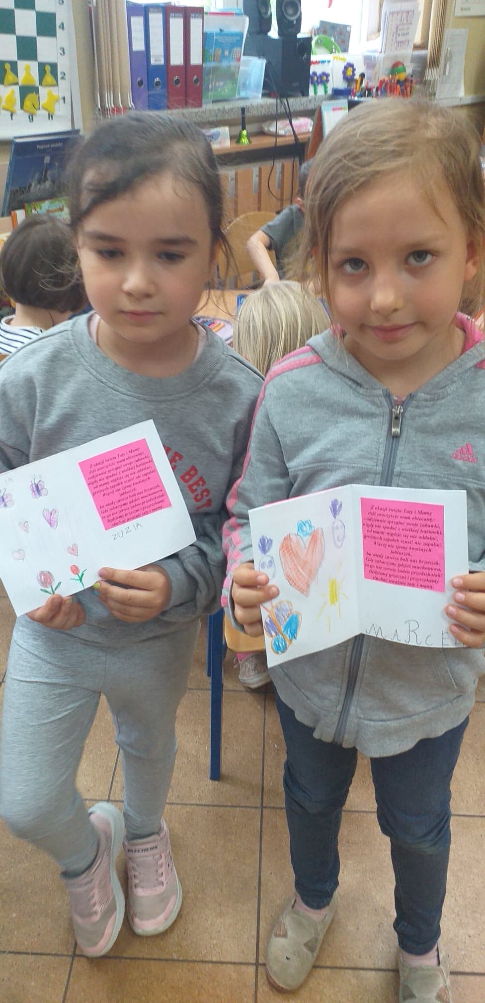 Dwie dziewczynki trzymające kartki z życzeniami 