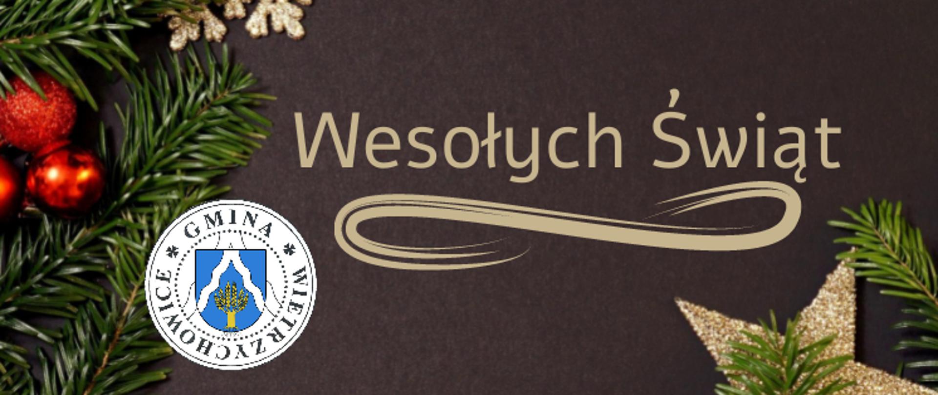 grafika przedstawia na ciemnym tle ozdobionym gałązkami choinki oraz dekoracjami świątecznymi napis Wesołych Świat. Poniżej widnieje herb gminy.