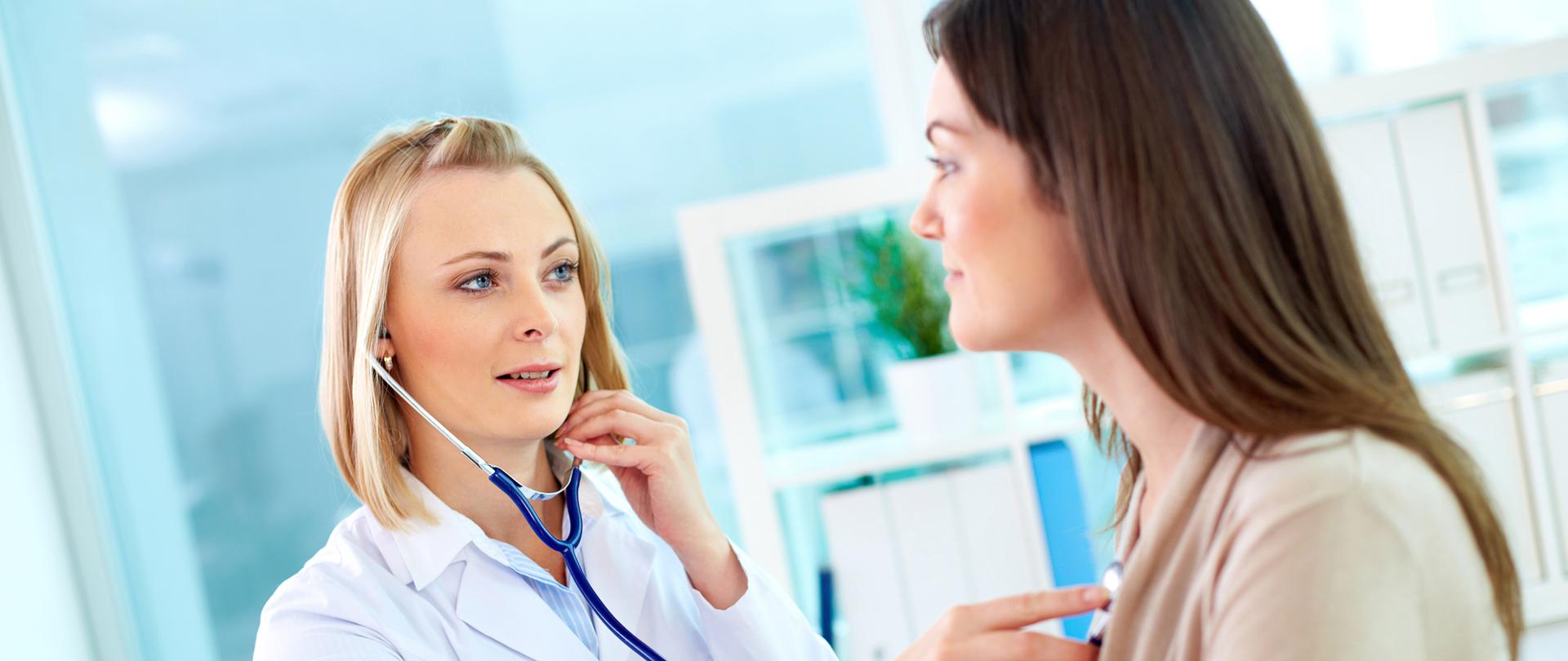 Portrait of confident practitioner checking heart beat of patient