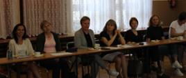 Nauczyciele biorący udział w szkoleniu siedzą przy stole