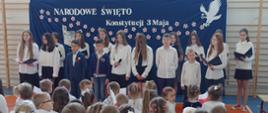 Uczniowie klas starszych na tle dekoracji - Narodowe Święto Konstytucji 3 Maja