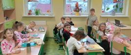 Uczniowie klasy 1 siedzą w ławkach i pracują nad projektem