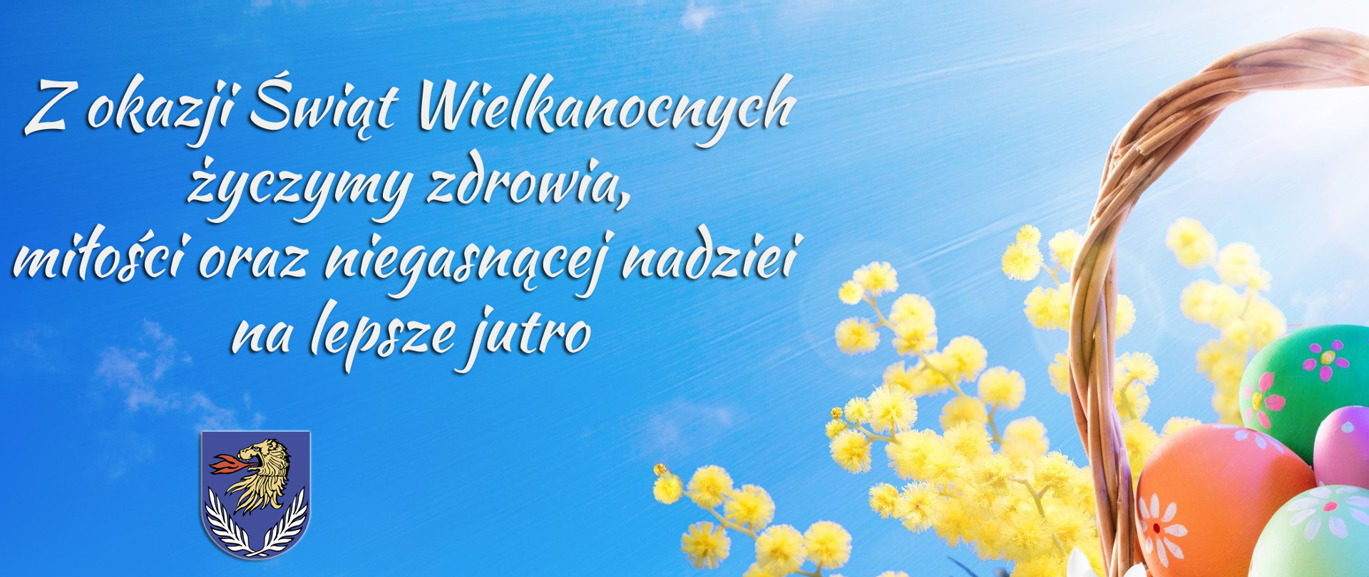 Ilustracja przedstawia koszyczek z wielkanocnymi pisankami, żółte i białe kwiaty leżące na zielonej trawie, na błękitnym tle treść życzeń: Z okazji Świąt Wielkanocnych życzymy zdrowia, miłości oraz niegasnącej nadziei na lepsze jutro. Wójt Gminy Wierzbica Bożena Deniszczuk Przewodniczący rady Gminy Zdzisław Muszański