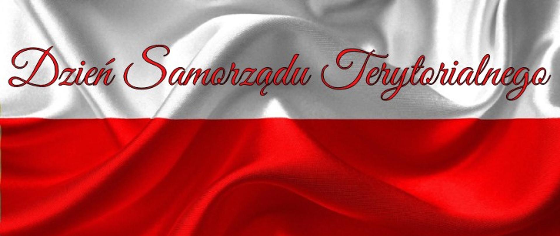 Na fotografii biało - czerwona flaga a na niej czerwony napis Dzień Samorządu Terytorialnego.