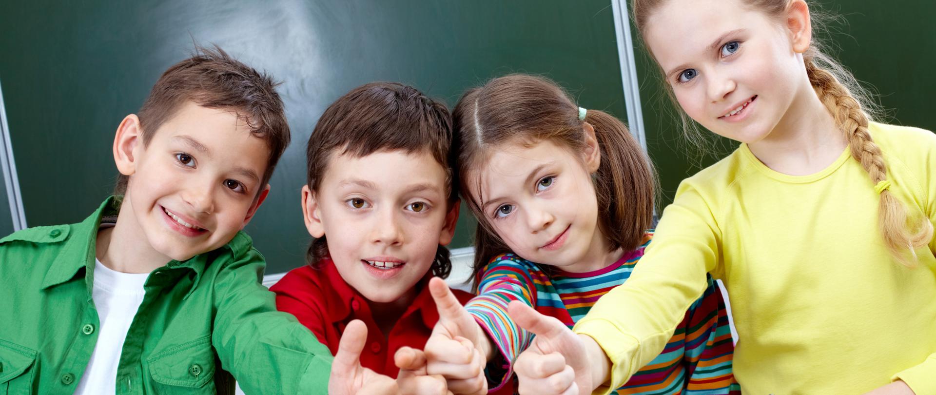 Group of four classmates showing sign of ok