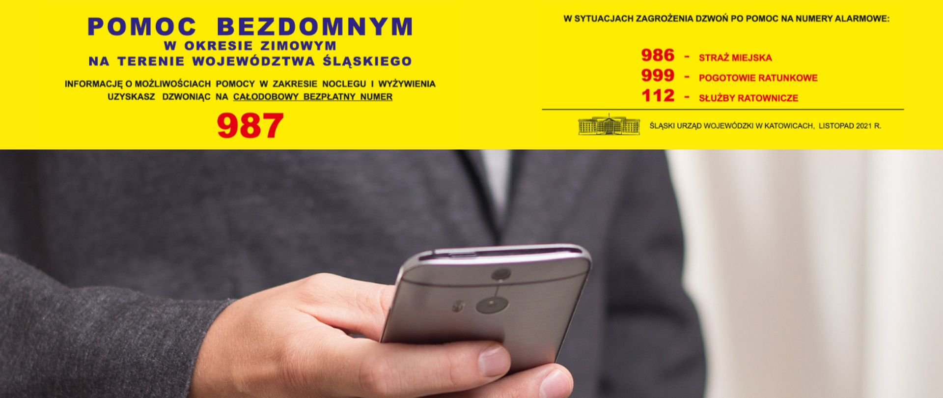 Pomoc bezdomnym - grafika promująca numer 987. Ręka trzymająca telefon komórkowy. Tekst w treści artykułu.