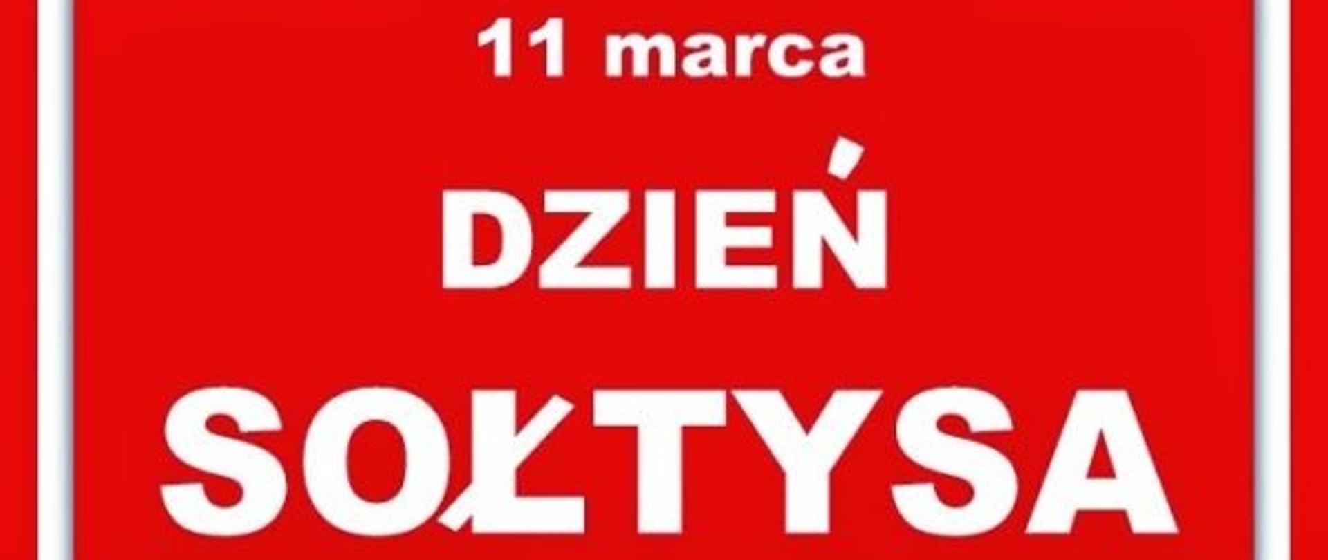 Czerwona tablica z napisem "11 marca Dzień Sołtysa"