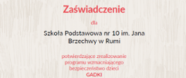 Szare tło, na dole po prawej stronie grafika psa z czerwoną chustą siedzącego na tle krzaka. Na górze kolorowe napisy. Na środku czarne napisy.