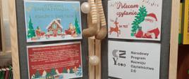 Gazetka z plakatami reklamującymi czytanie książek, zwłaszcza o tematyce świątecznej, na gazetce siedzi skrzat w żółtym ubranku