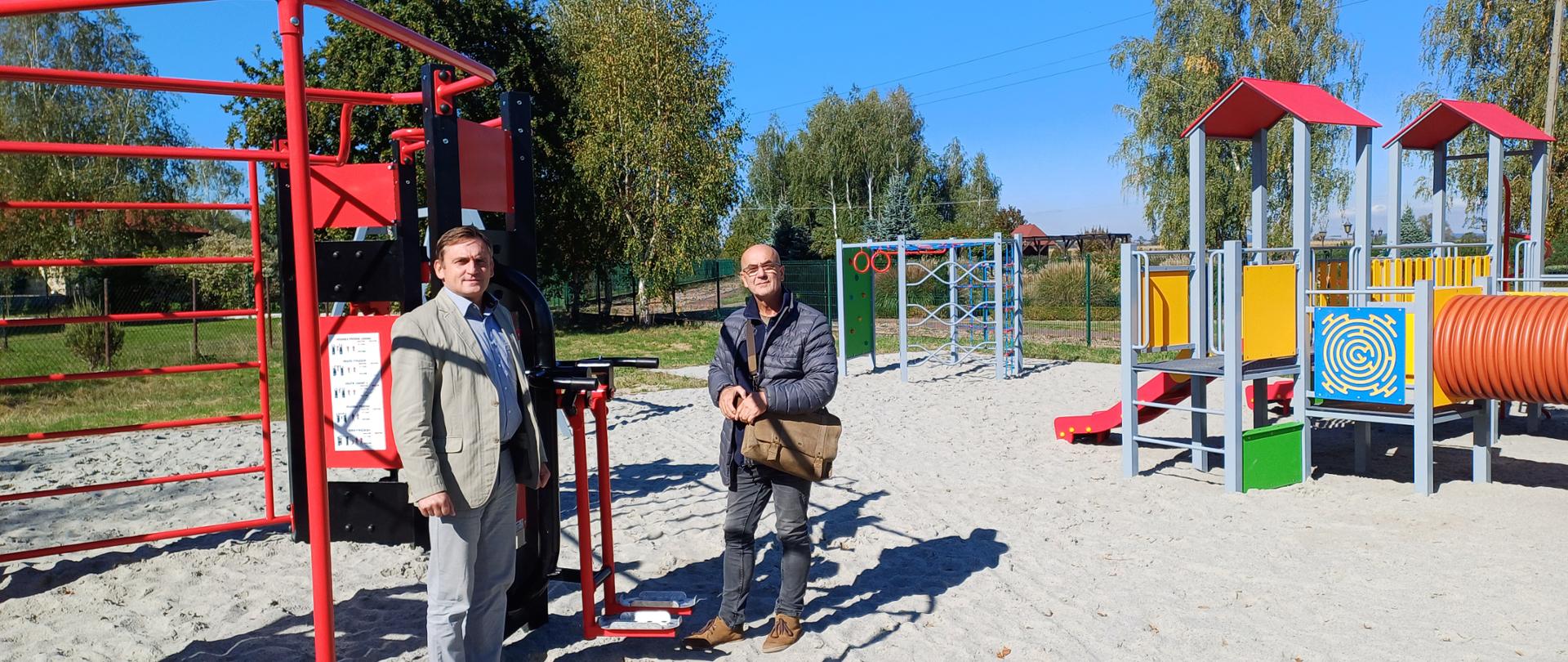 Zdjęcie przedstawia plac zabaw. od lewej Wójt Gminy Wietrzychowice oraz przedstawiciel firmy realizującej zadanie