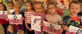 Grupa dzieci podczas pozuje do zdjęcia z plakatami w ramach ogólnopolskiej akcji BohaterON