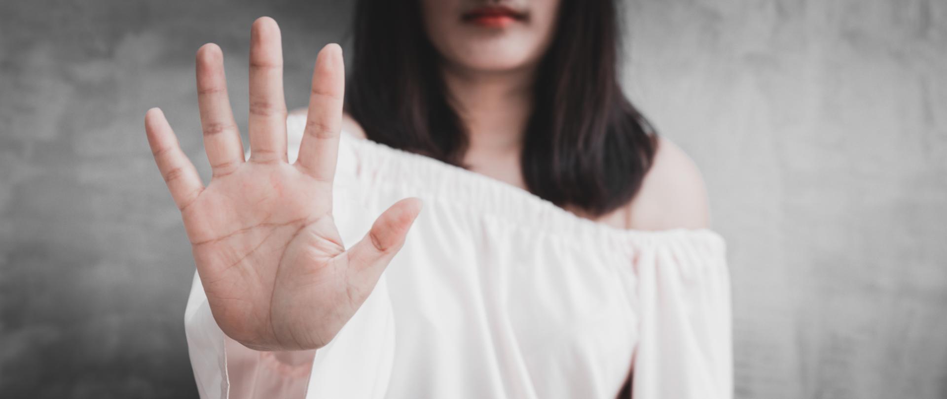 Closeup portrait young annoyed angry woman with bad attitude giving talk to hand gesture with palm outward isolated grey wall background. Negative human emotion face expression feeling body language.
