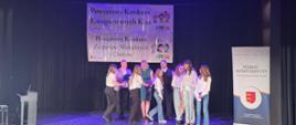 Wyróżnione w konkursie dziewczynki odbierają dyplom i gratulacje na scenie