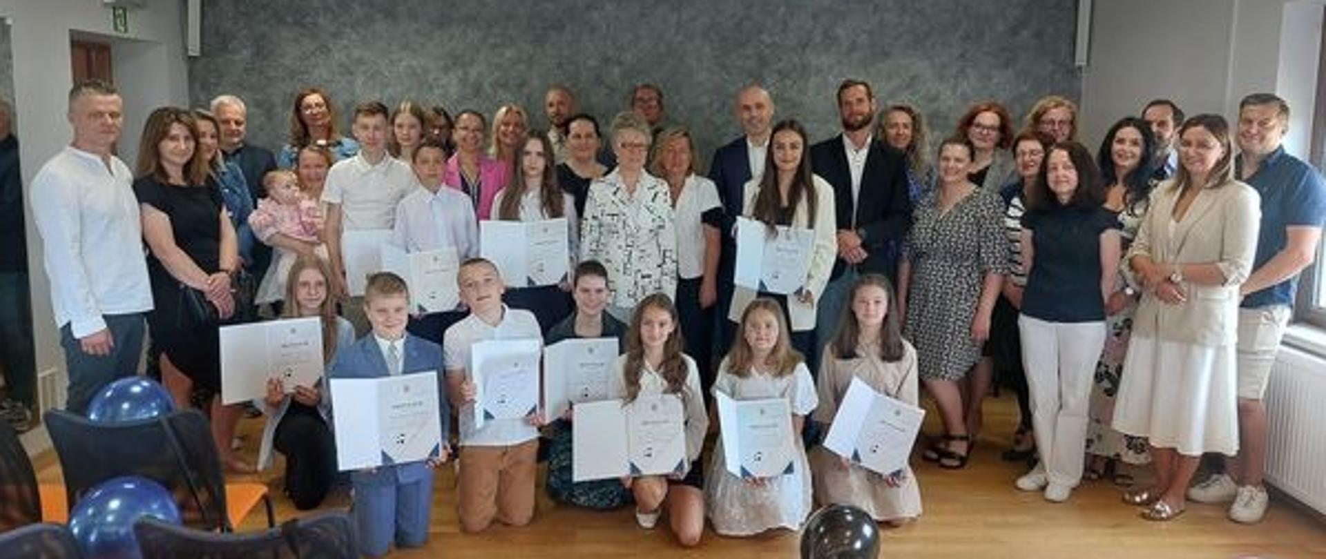 Uczniowie szkół podstawowych z terenu Gminy Spytkowice w sali obrad UG wraz z wójtem, dyrektorami, nauczycielami oraz radnymi.