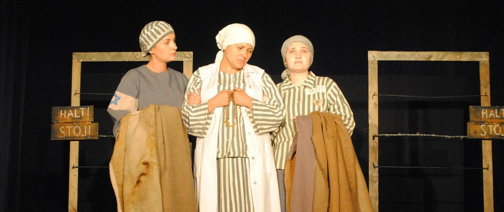 trzy kobiety w pasiastych sukienkach stoją na scenie 