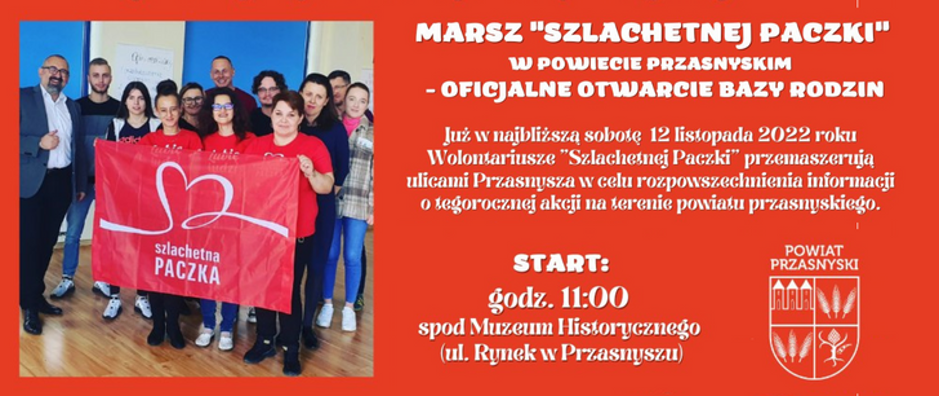 Grafika przedstawia informację o organizowanym w Przasnyszu "Marszu Szlachetnej Paczki" - treść w artykule. Grafika utrzymana w biało czerwonej kolorystyce - czerwone tło, biała czcionka napisów oraz biały herb Powiatu Przasnyskiego. Po lewej zdjęcie ze Starostą Krzysztofem Bieńkowskim oraz wolontariuszami Szlachetnej Paczki, razem trzymają flagę z logotypem "Szlachetna Paczka".