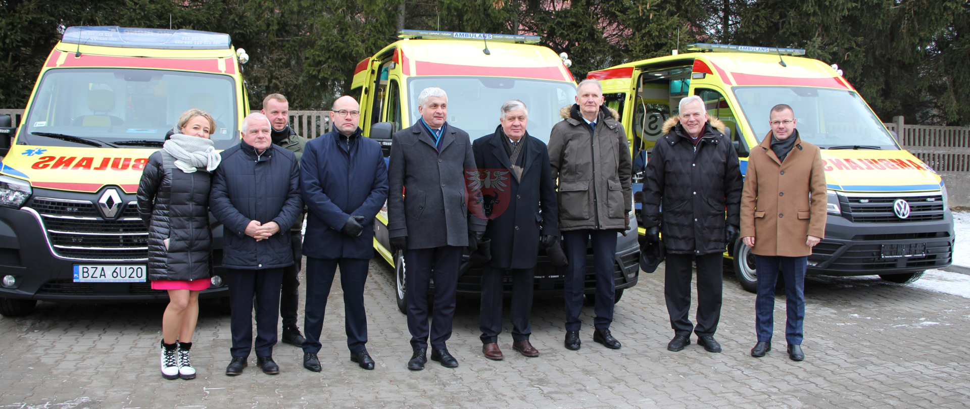 grupowe zdjęcie przy karetkach z delgacją