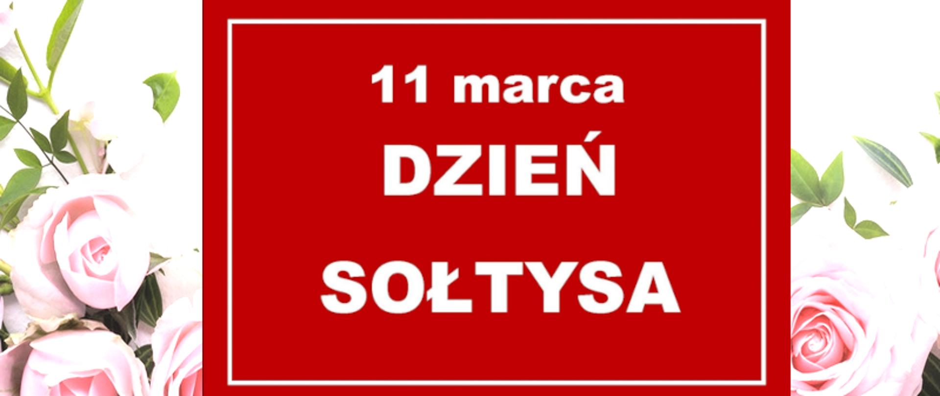 Czerwona tablica z napisem 11 marca Dzień Sołtysa na tle bukietu róż