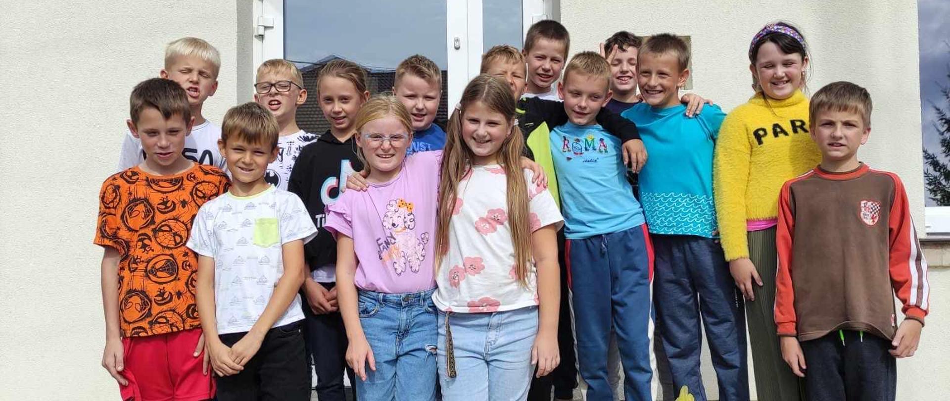 Uczniowie sprzątający otoczenie szkoły