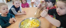 Dzieci w trakcie krojenia owoców - witaminowe przyjęcie. Pokrojone owoce lądują w misce