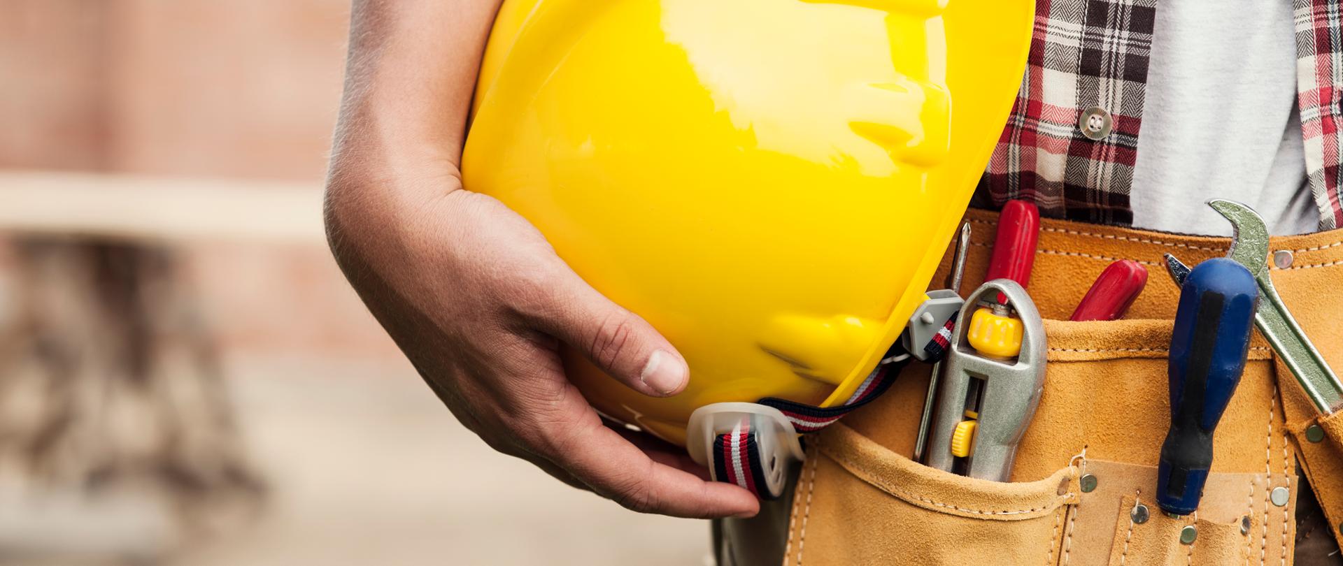Close-up of hard hat holding by construction worker