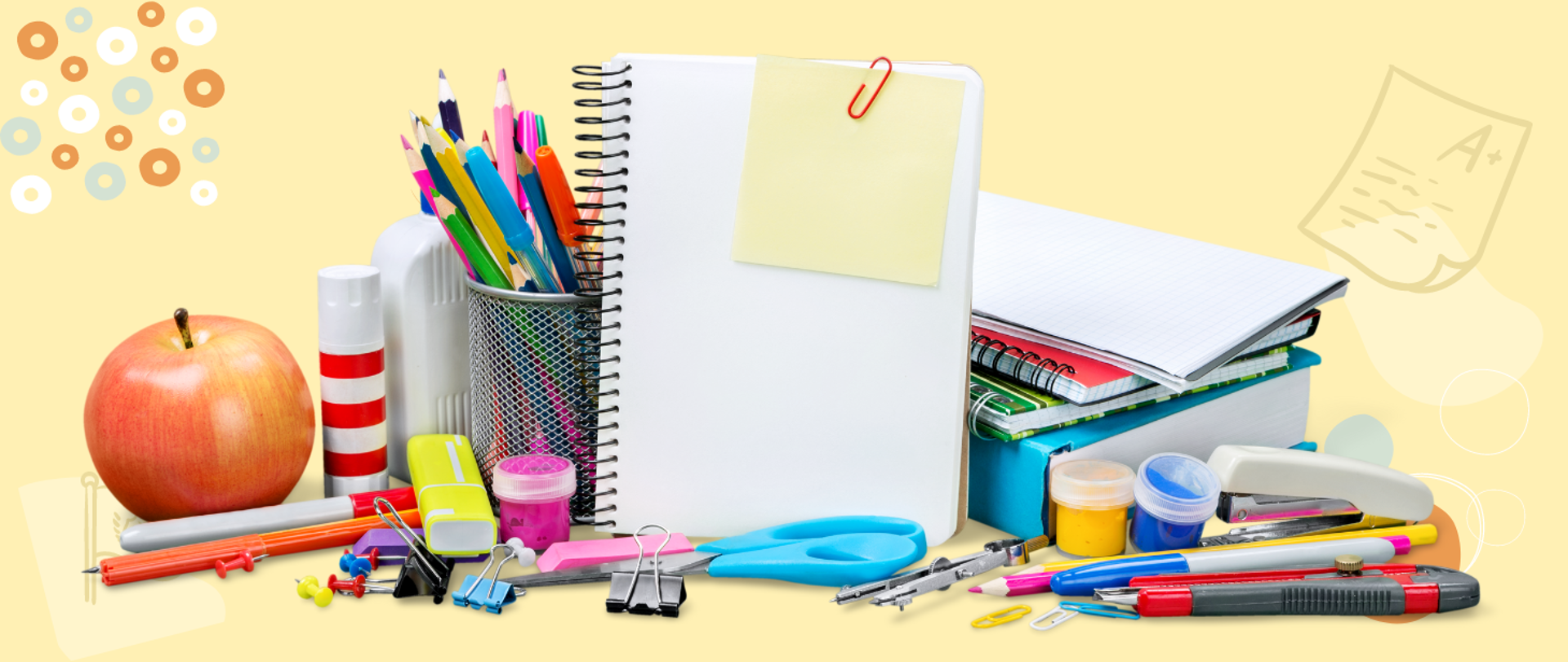Zdjęcie przedstawiające przybory szkolne, kredki, zeszyty, farby, klej, jabłko