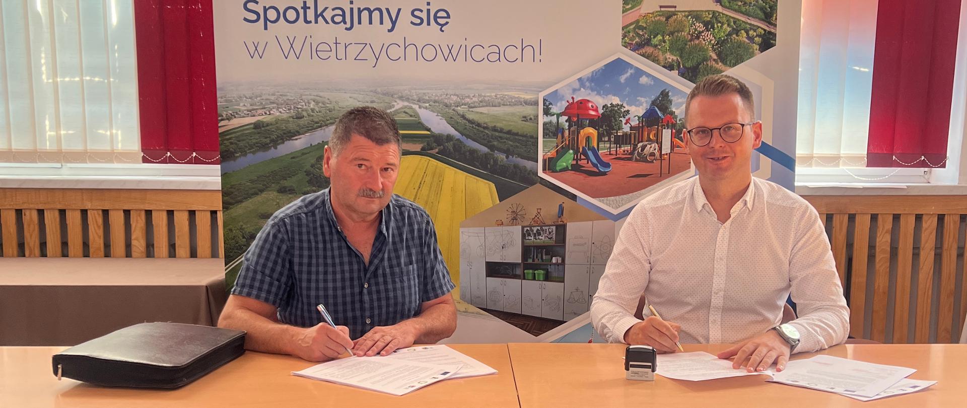 Zdjęcie przedstawia od lewej Pana Andrzeja Pudełko, Wójta Gminy Wietrzychowice w trakcie podpisywania umowy na modernizację i doposażenie Domu Ludowego w Demblinie