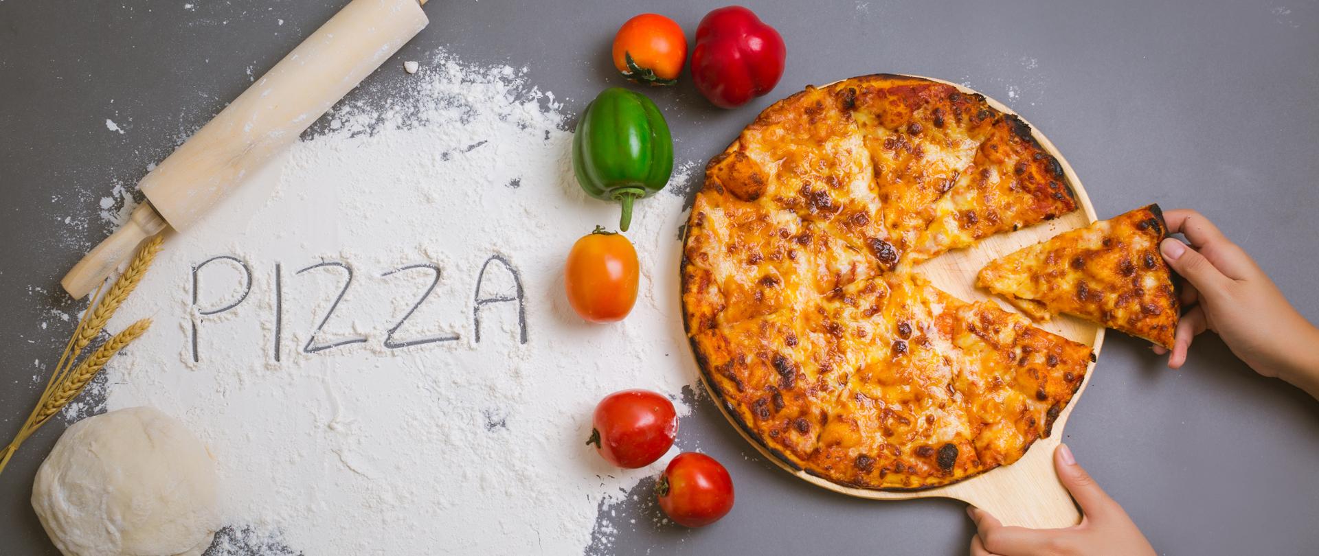 chef making pizza at kitchen