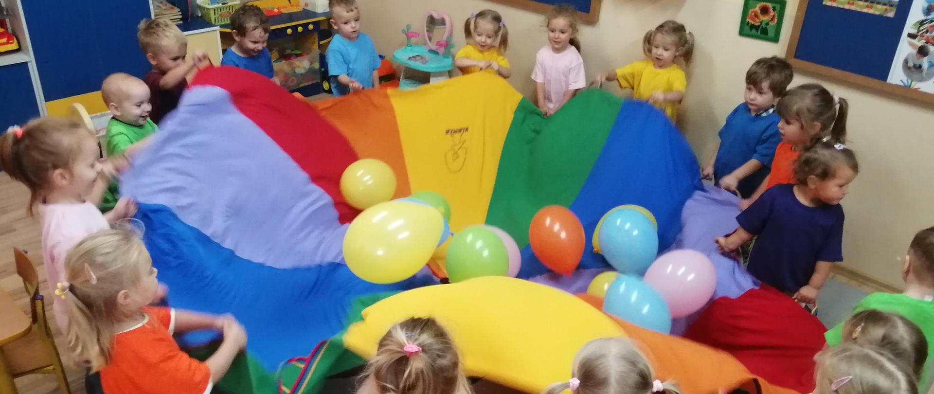 Dzieci bawią się chustą animacyjną i balonami 