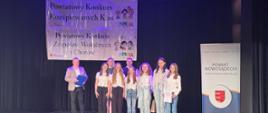 Wyróżnione w konkursie dziewczynki odbierają dyplom i gratulacje na scenie