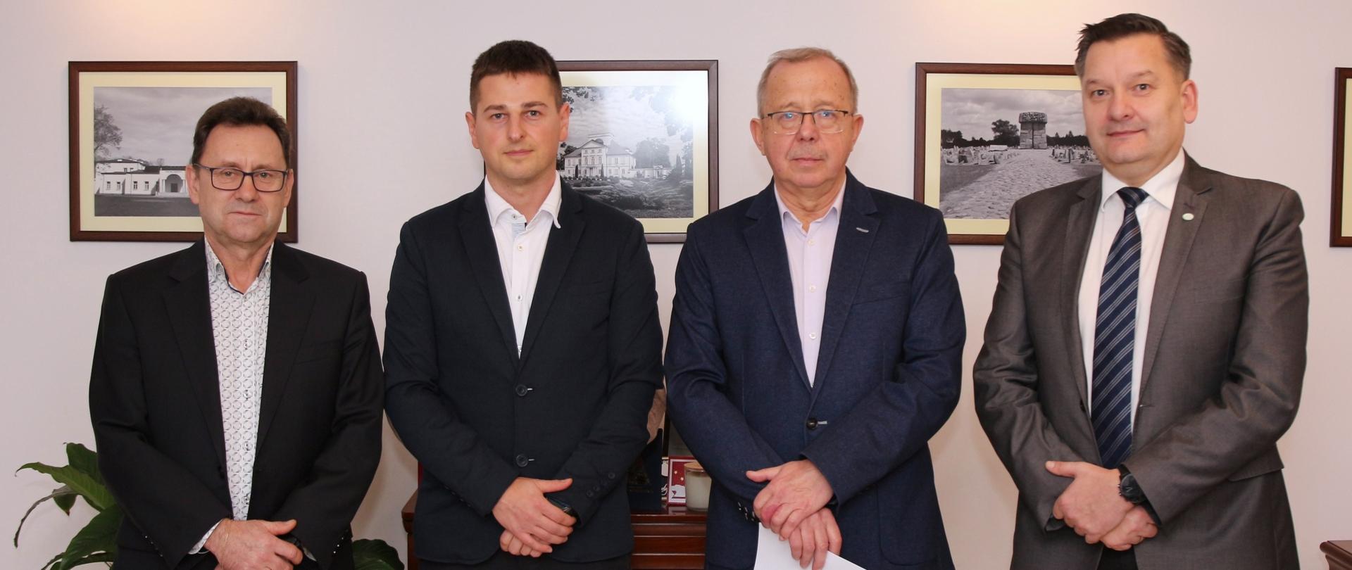 Na zdjęciu w gabinecie, na tle ściany z obrazkami wykonano zdjęcie, na którym widzimy starostę sokołowskiego, wicestarostę oraz dotychczasowego i nowego Powiatowego Inspektora Nadzoru Budowlanego.