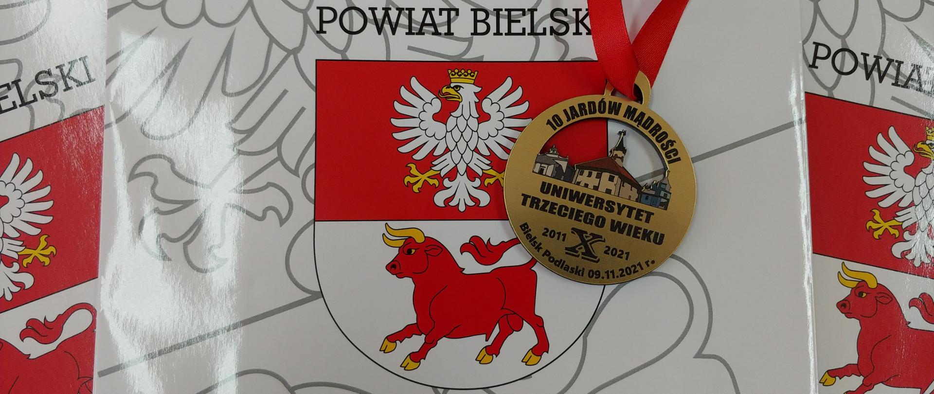 Jubileusz Bielskiego Stowarzyszenia Uniwersytet Trzeciego Wieku - okolicznościowy medal na tle herbu powiatu