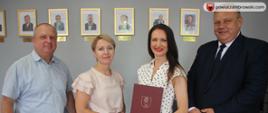 grupowe zdjęcie na którym znajdują się następujące osoby od lewej wicestarosta zambrowski, skarbnik gminy Szumowo, starosta zambrowski i wójt gminy Szumowo