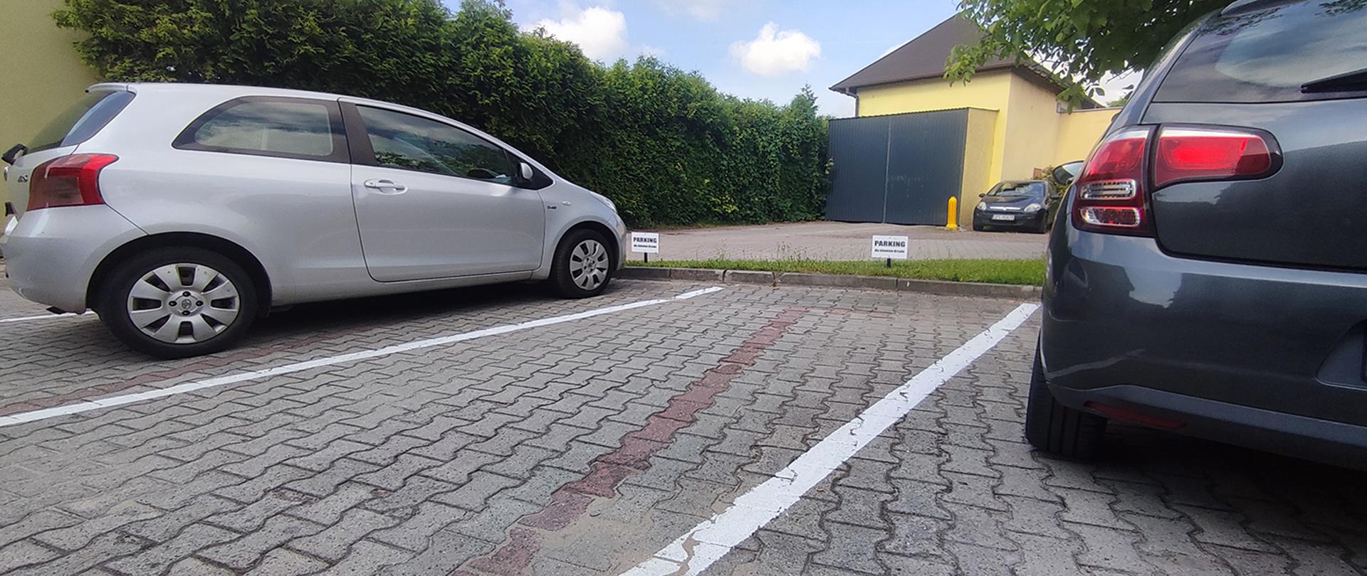 Samochody stojące na wyznaczonych miejscach parkingowych.