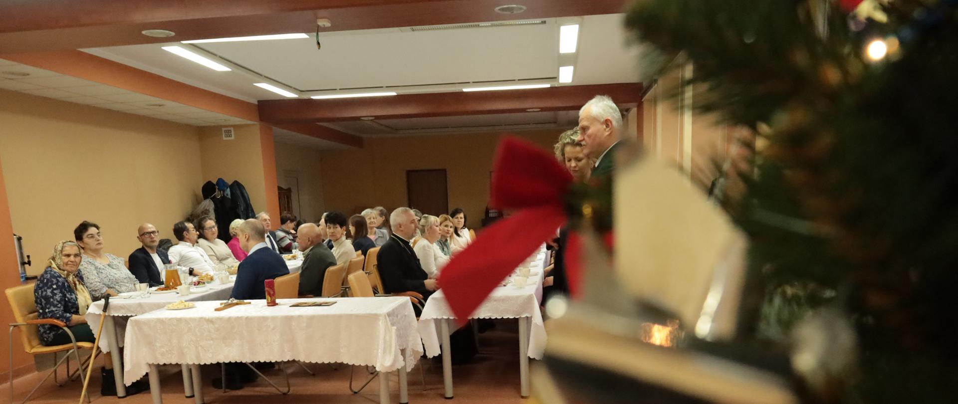 Uczestnicy spotkania - widok za choinki