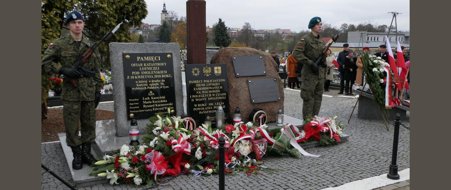 Złożone wiązanki i znicze przy Krzyżu Katyńskim na cmentarzu parafialnym w Lipsku.