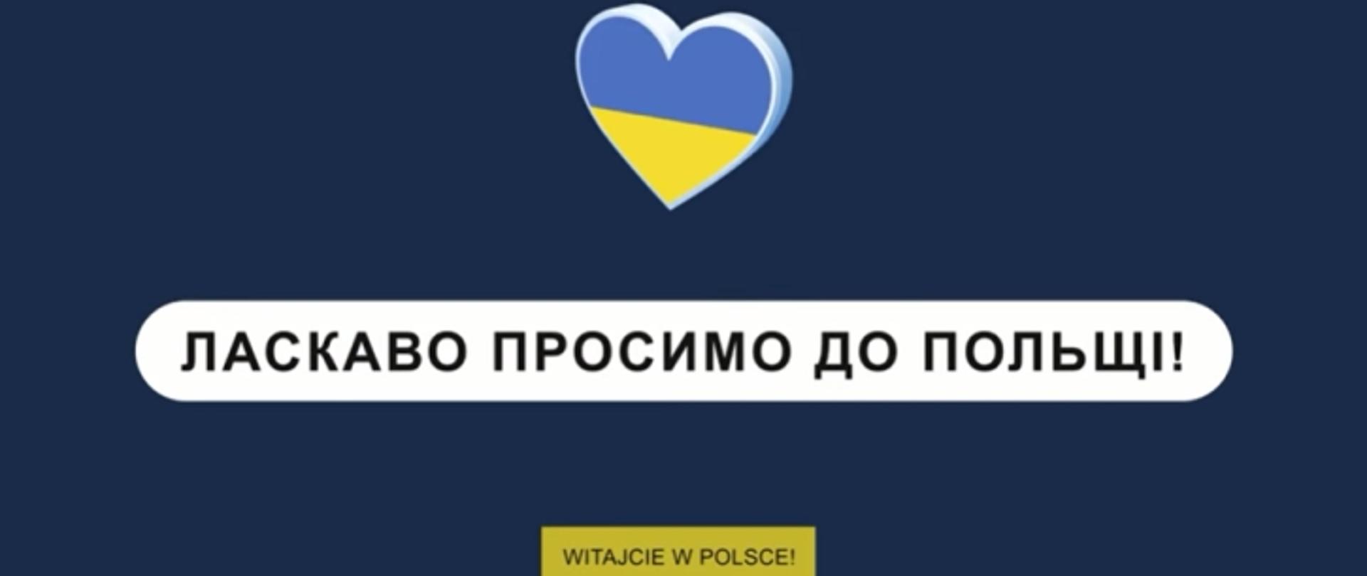 Serce w kolorze flagi ukraińskiej niebiesko żółtej, pod nim czarny napis na białym tle po ukraińsku "Witajcie w Polsce" a niżej w żółtym prostokącie po polsku. Tło grafiki granatowe.