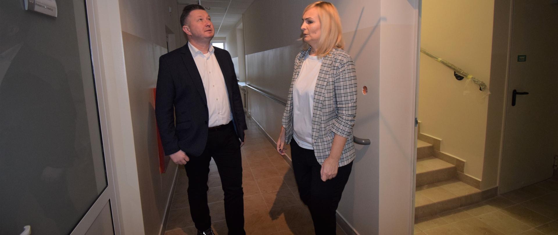 Odnowiony korytarz z balustradami oglądają starosta i dyr. DPS
