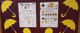 Tablica z dwoma plakatami informacyjnymi na temat raka czerniaka i żółtaczki, po lewej i prawej stronie wycięte z papieru żółte parasolki 