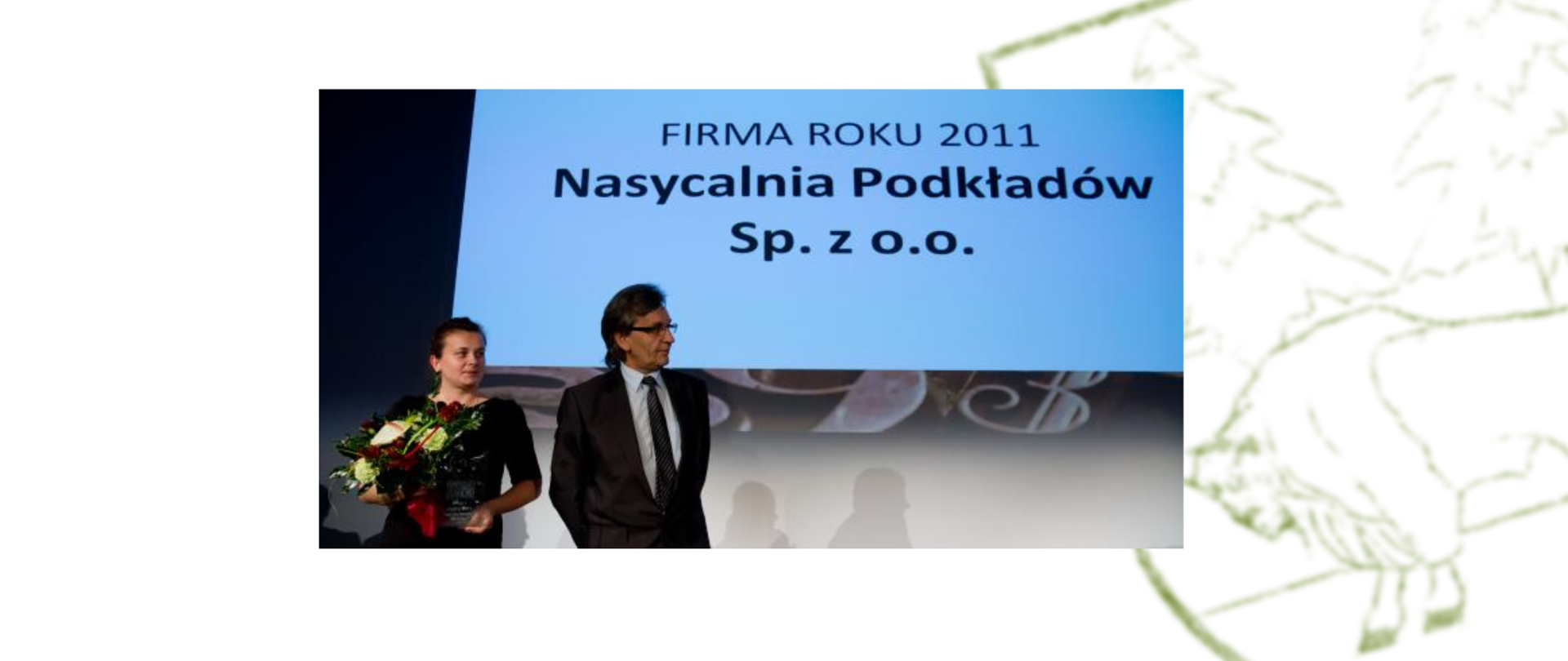 Nasycalnia Podkładów w Czeremsze - Prezes firmy na tle napisu na telebimie "Firma roku 2011 Nasycalnia Podkładów Sp. z o.o."